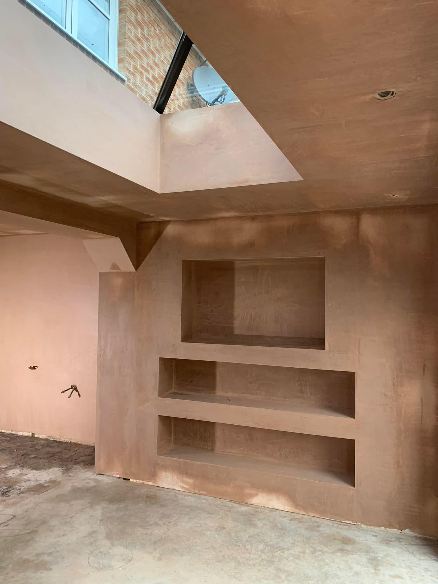 Formed alcove shelving plastered smooth under a lantern roof light